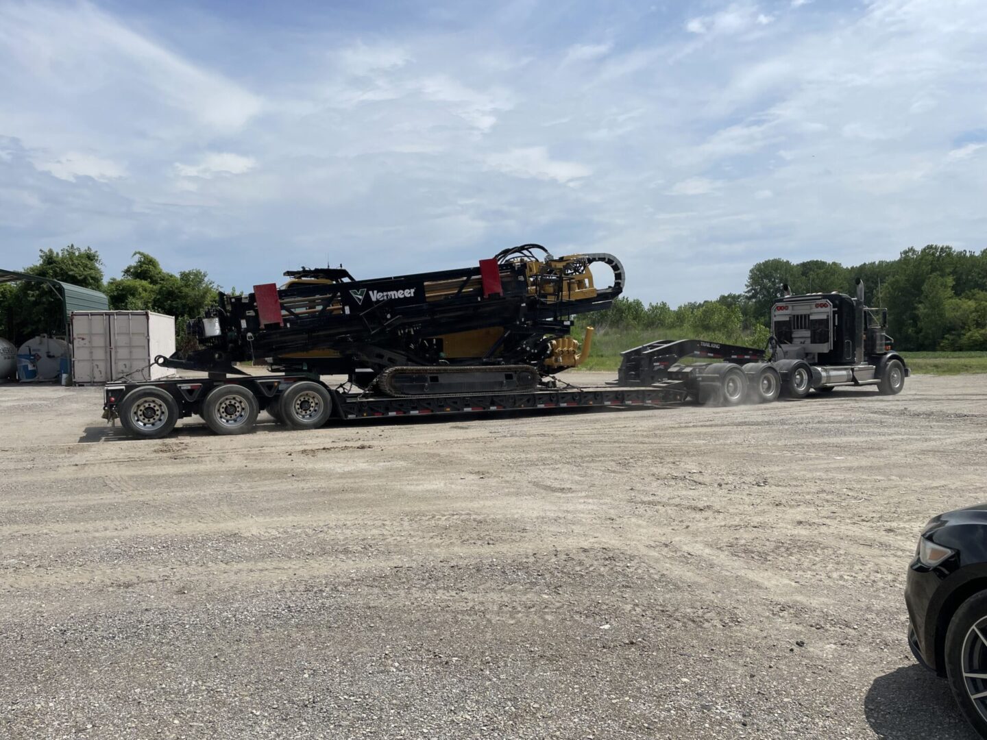 A large truck is pulling a trailer down the road.